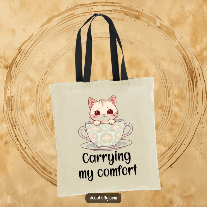 Funny Tote Bag showing a cat peeking out from a large, patterned teacup, perfect for carrying essentials.